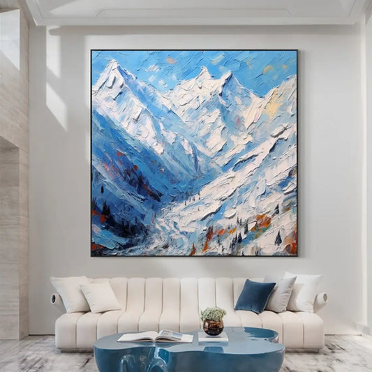 Room mockup showing jagged snow-covered mountains in blue and white above a deep blue valley with small dark trees and warm accents.
