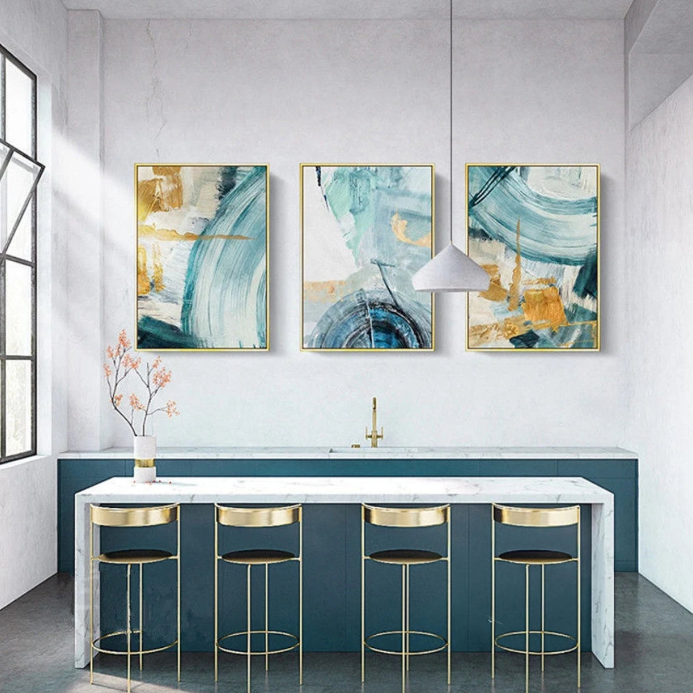 Room mockup showing three abstracts with sweeping teal and pale blue arcs over cream fields with gold-coloured geometric accents.