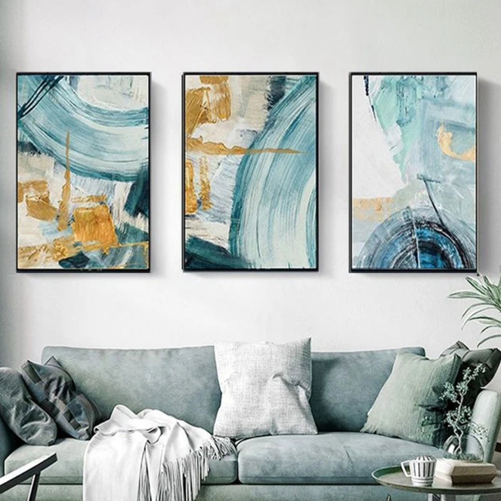 Room mockup showing three abstracts with sweeping teal and pale blue arcs over cream fields with gold-coloured geometric accents.