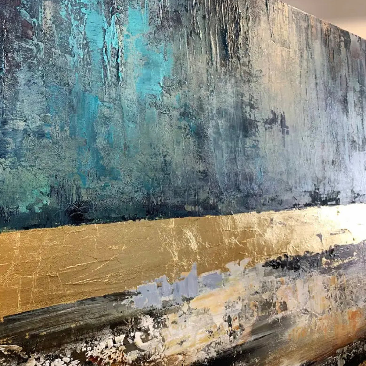 Close-up. Deep teal above broad gold-coloured and brown horizontal bands, with rough black, cream and white textured strokes below.