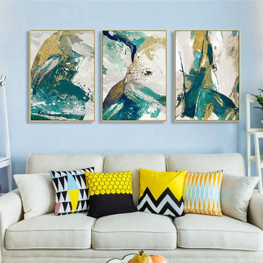 Room mockup showing three abstract panels with flowing teal, white and gold-coloured fields and sweeping dark marks.