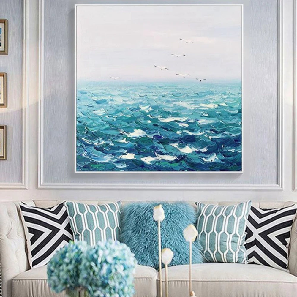 Room mockup showing textured turquoise waves with dark blue troughs beneath a pale sky dotted with small birds.
