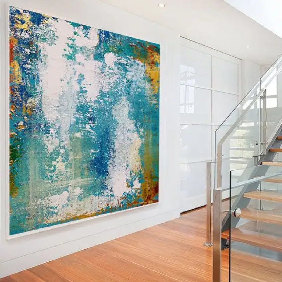 Room mockup. Scuffed white patches overlap turquoise and blue fields, with ochre and orange textured edges.