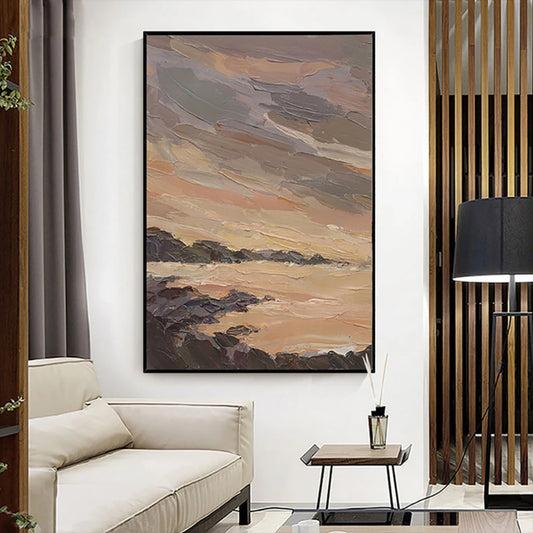 Room mockup showing layered grey and warm beige clouds over pale water and dark rocky shoreline.