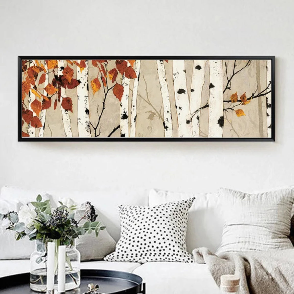 Room mockup showing white birch trunks with black bark marks and sparse rust-orange leaves against a warm beige background.