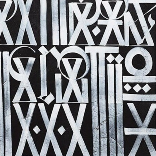 Close-up. White circles, triangles and elongated letter-like symbols arranged in rows across grey.
