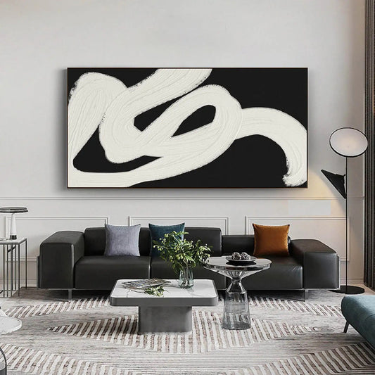 Room mockup. A broad white looping brushstroke sweeps across black, with visible ridges and feathered ends.
