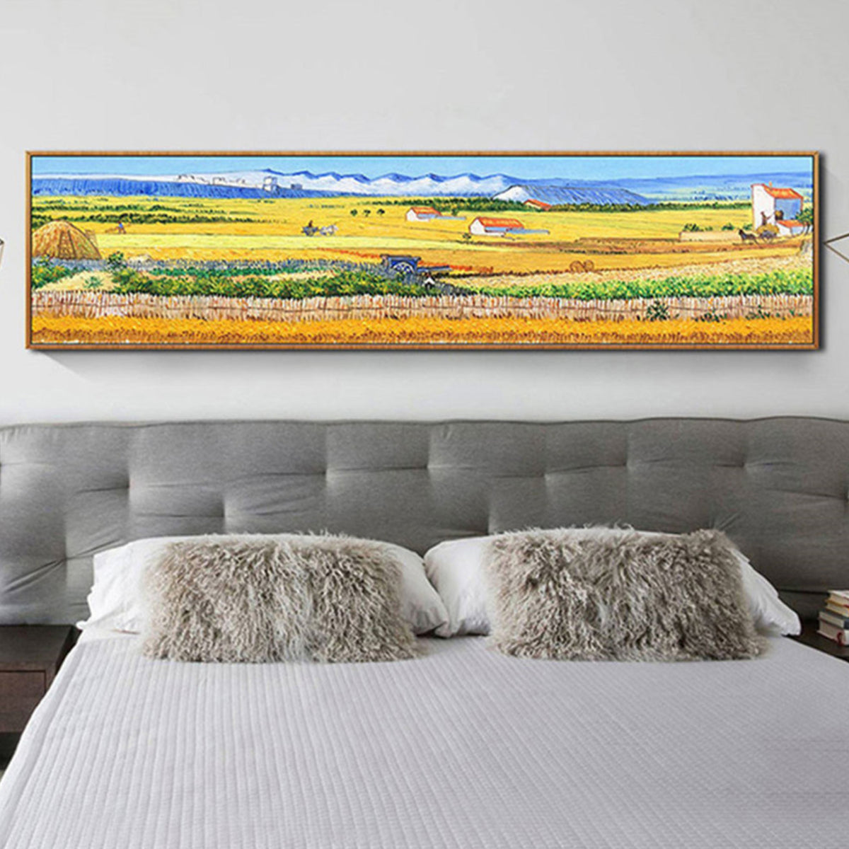 Room mockup. A panoramic landscape of yellow and green fields, small farm buildings and distant blue hills beneath pale sky.
