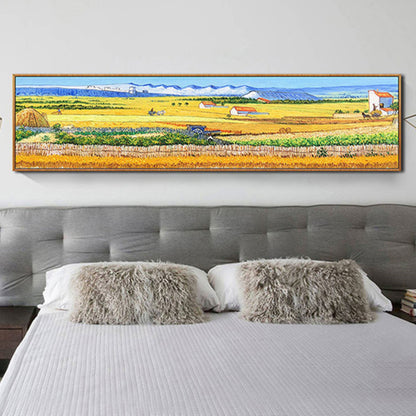 Room mockup. A panoramic landscape of yellow and green fields, small farm buildings and distant blue hills beneath pale sky.