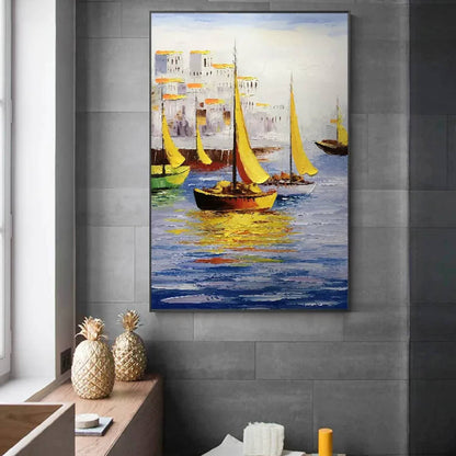 Room mockup. Yellow sails and dark boat hulls reflected in blue water beside pale waterfront buildings with warm yellow accents.
