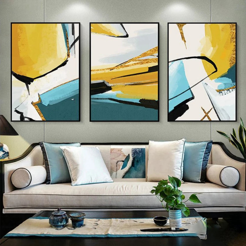 Room mockup showing three abstracts with bold yellow, teal and white geometric fields crossed by sweeping black lines.
