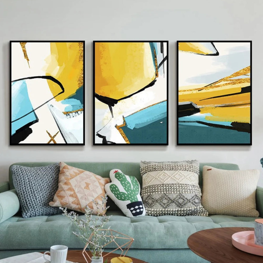 Room mockup showing three abstracts with bold yellow, teal and white geometric fields crossed by sweeping black lines.