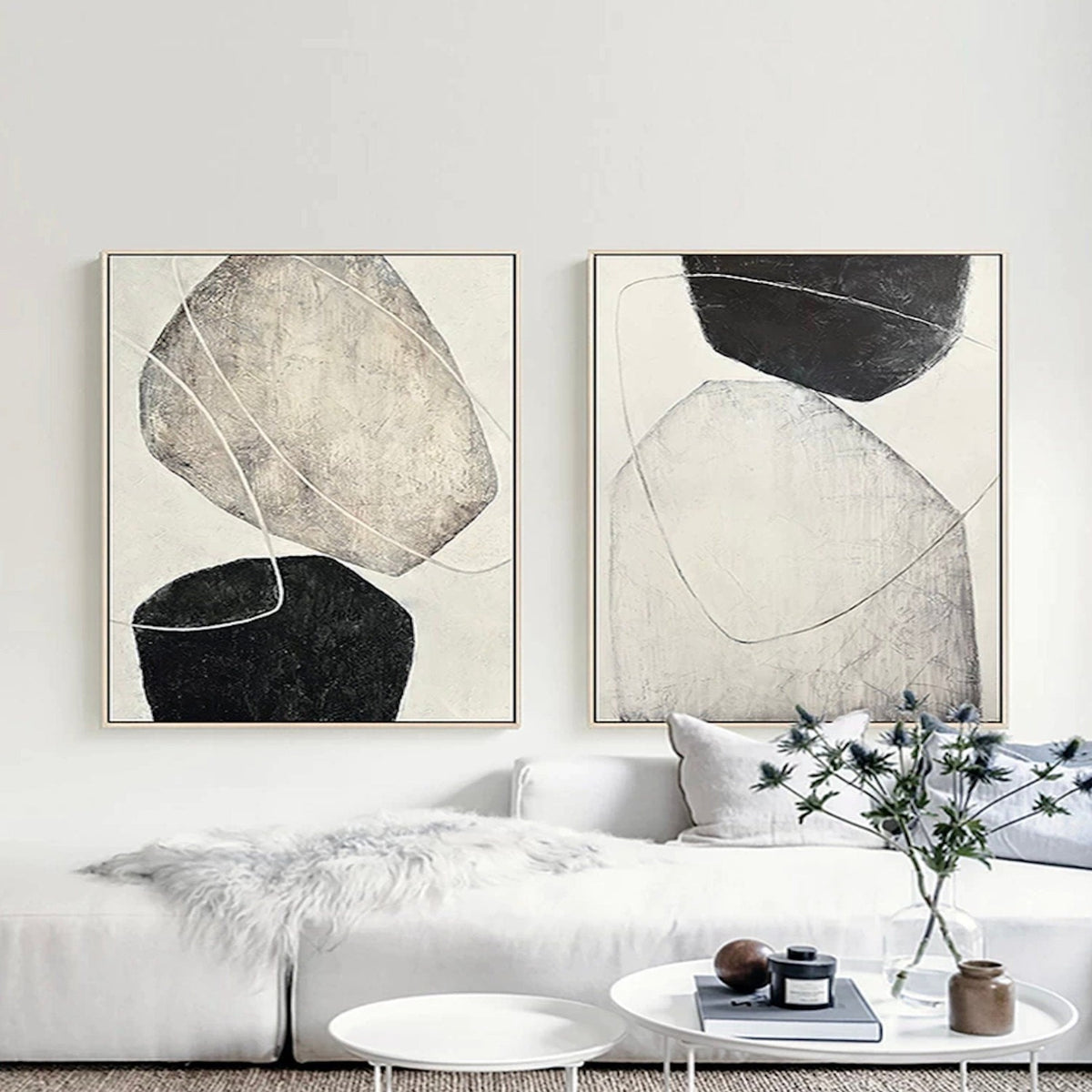 Room mockup. Two complementary beige, black and cream abstract paintings with rounded shapes and fine pale curves.