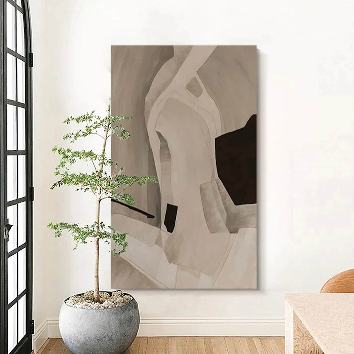 Room mockup. Soft cream and taupe curved bands surround a dark brown angular patch and a small black block.
