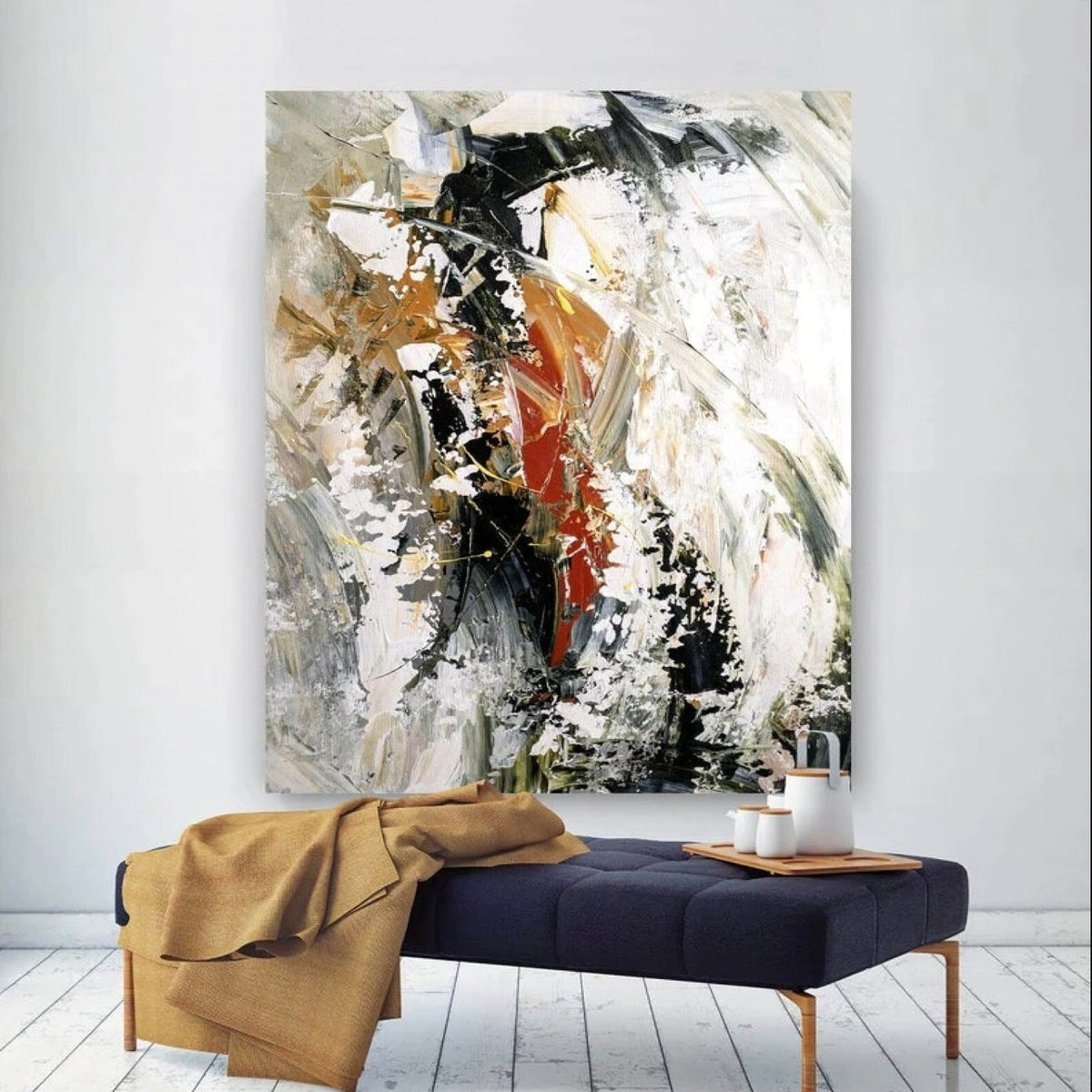 Room mockup. Broad black and white textured strokes with rust-red and ochre accents in a swirling abstract composition.