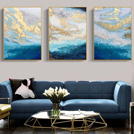Room mockup. Three complementary panels with pale blue and white cloud-like strokes, gold-coloured accents and deep blue lower waves.