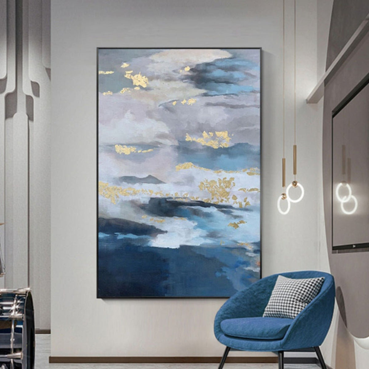 Room mockup. Layered blue, grey and white cloud-like bands with scattered gold-coloured patches above deep blue lower strokes.