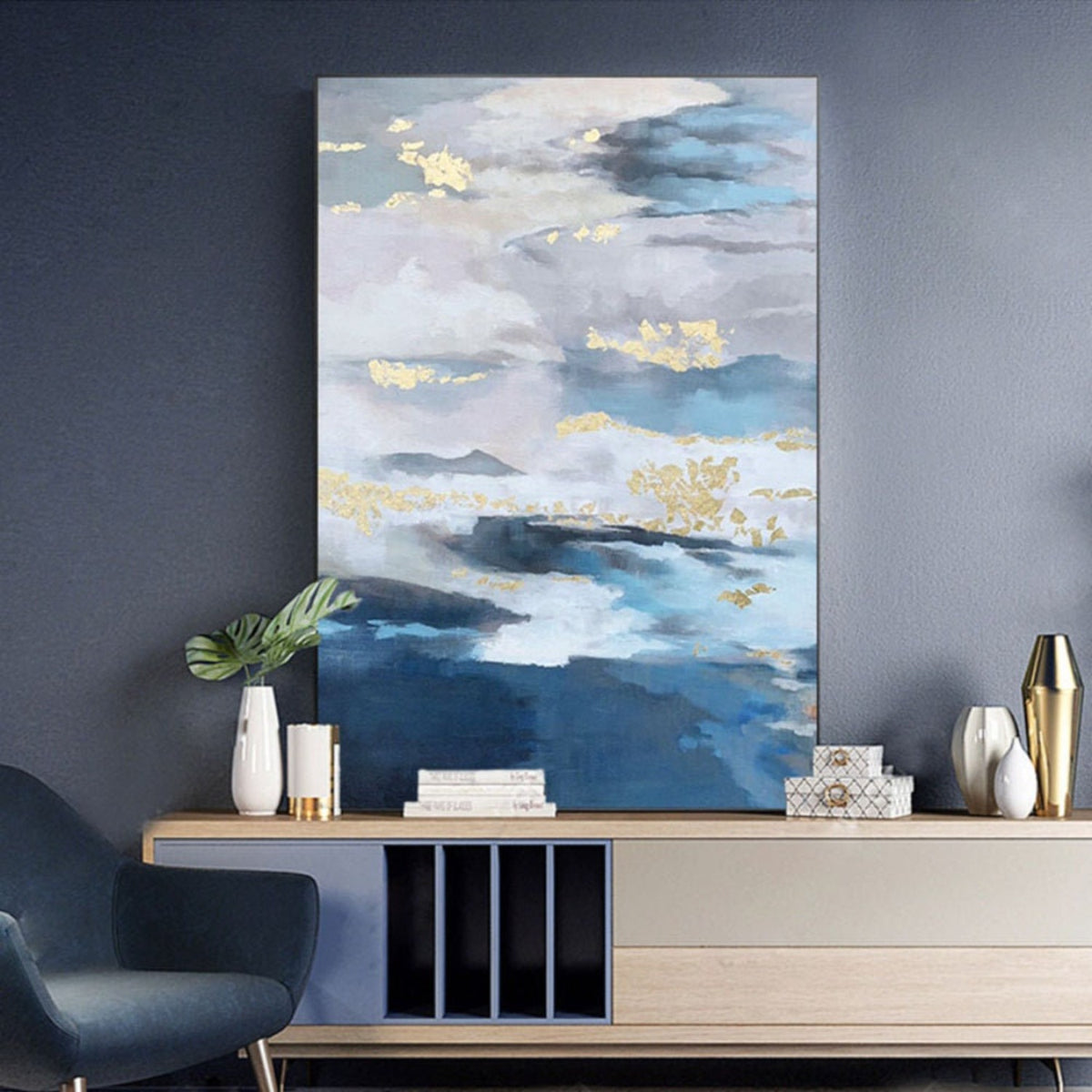 Room mockup. Layered blue, grey and white cloud-like bands with scattered gold-coloured patches above deep blue lower strokes.