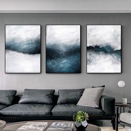 Room mockup. Three-panel artwork with turbulent dark blue and grey wave-like strokes beneath white misty areas.