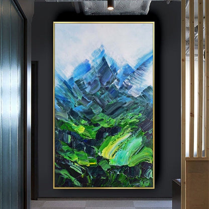 Room mockup. Angular blue mountain peaks rise above a vivid green valley with sweeping textured green and turquoise strokes.