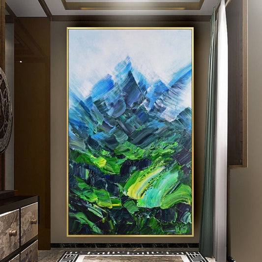 Room mockup. Angular blue mountain peaks rise above a vivid green valley with sweeping textured green and turquoise strokes.