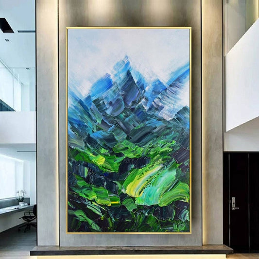 Room mockup. Angular blue mountain peaks rise above a vivid green valley with sweeping textured green and turquoise strokes.