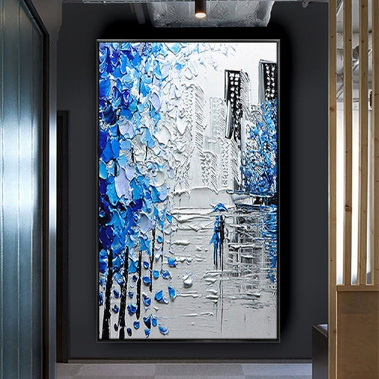Room mockup. Thick blue and white tree-like marks frame grey city buildings and a small blue figure on a reflective street.