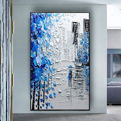 Room mockup. Thick blue and white tree-like marks frame grey city buildings and a small blue figure on a reflective street.