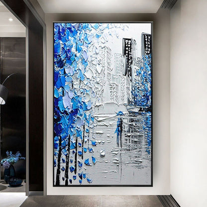Room mockup. Thick blue and white tree-like marks frame grey city buildings and a small blue figure on a reflective street.