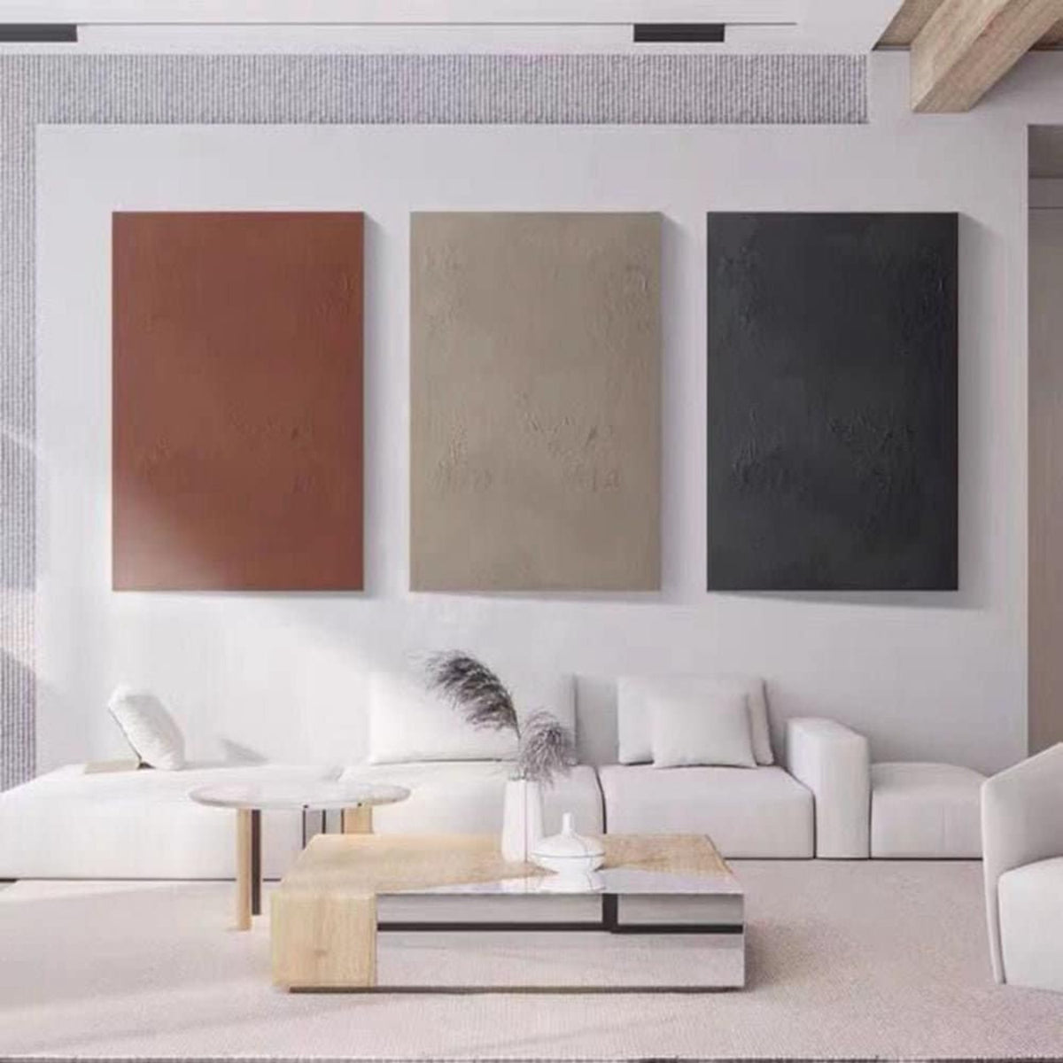 Room mockup. Three-panel minimalist artwork with plain textured brown, beige and charcoal rectangular fields.