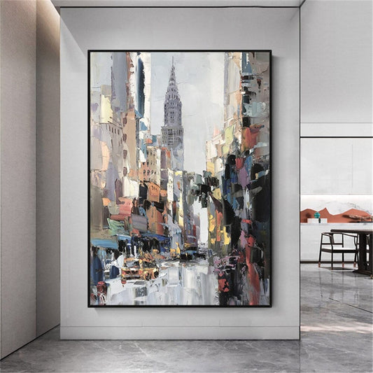 Room mockup. A busy street between tall grey and warm peach buildings leads toward a pointed skyscraper beneath a pale sky.