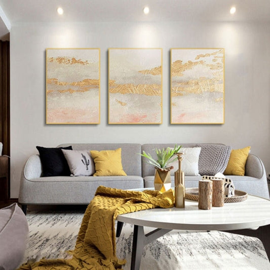Room mockup. Three-panel artwork with cream, grey and soft pink fields crossed by rough gold-coloured bands.