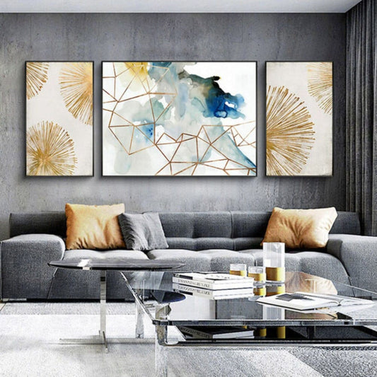 Room mockup. Three-panel artwork with cream and teal fields, fine gold-coloured geometric lines and radiating fan shapes.