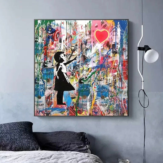 Room mockup. A black-and-white girl reaches toward a red heart balloon over dense colourful graffiti marks and white drips.