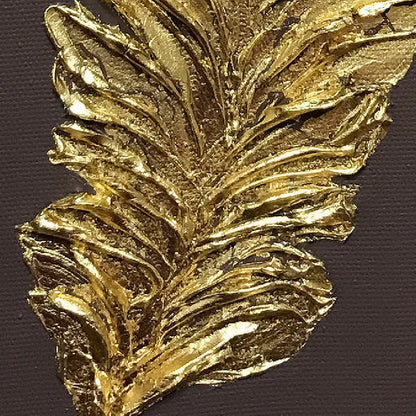 Close-up of single gold-coloured feather with layered raised barbs on a dark brown background.