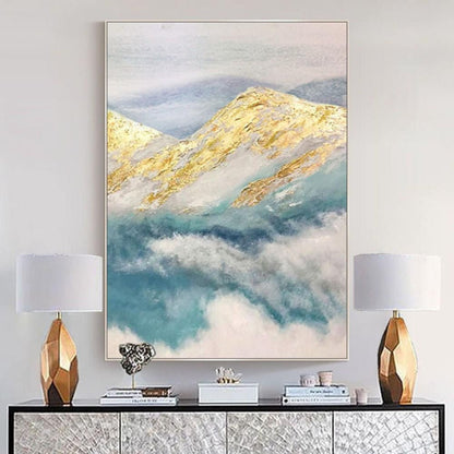 Room mockup. Gold-coloured mountain ridges rise above soft teal and white cloud-like strokes beneath a pale grey sky.