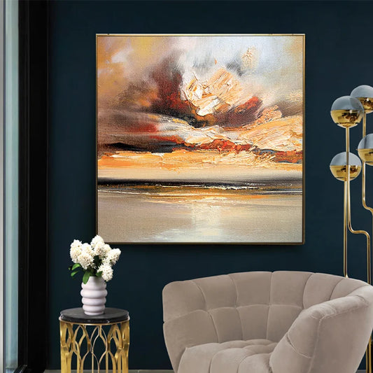 Room mockup showing cream, gold-coloured and orange cloud-like strokes above a dark horizontal horizon and pale reflective water.