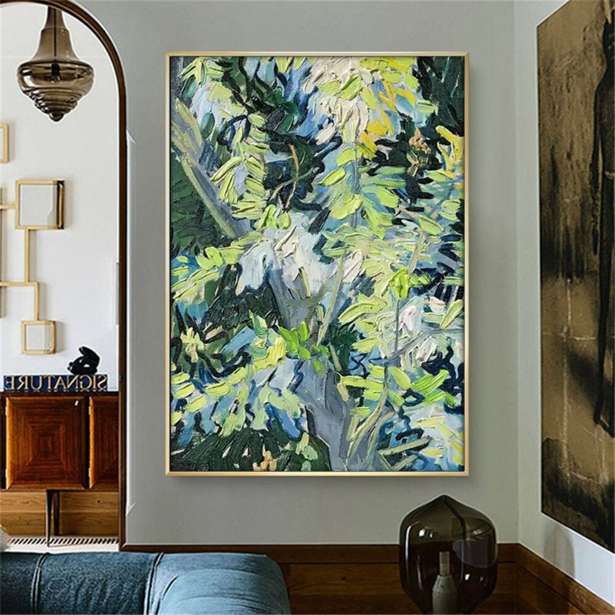 Room mockup. Loose green, yellow and pale blue leaf-like strokes overlap dark navy branches and a deep green background.