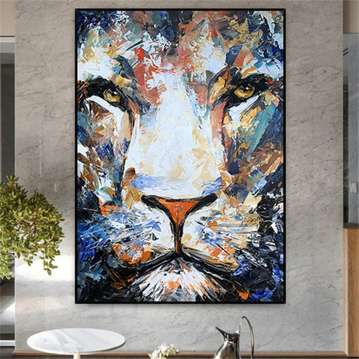 Room mockup. Close frontal lion face built from blue, white, ochre and orange strokes, with golden eyes and a dark muzzle.