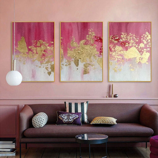 Room mockup. Three-panel artwork with magenta fading into white and textured gold-coloured central patches.