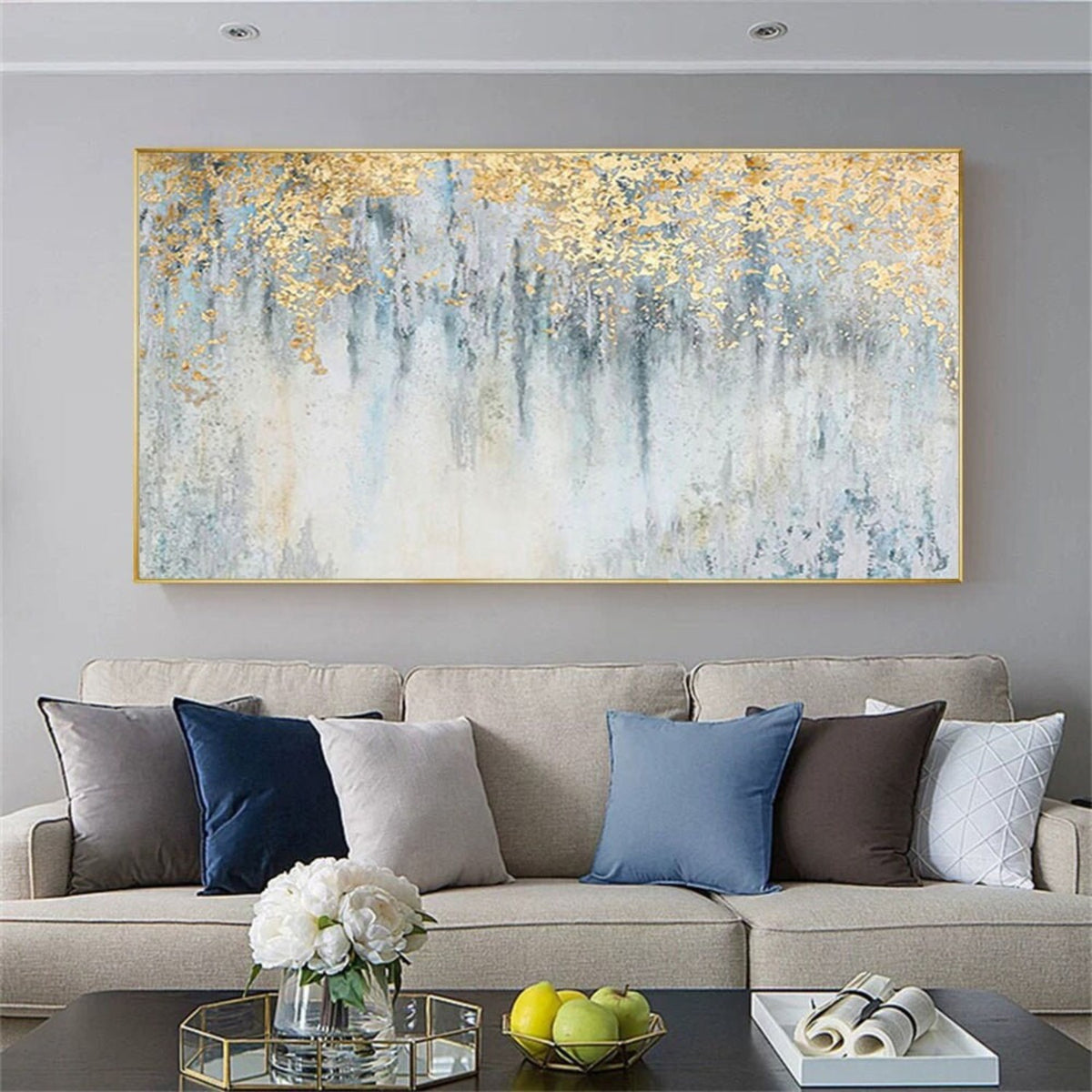 Room mockup. Gold-coloured textured foliage-like marks hang over fine dark vertical drips on a pale blue and white field.