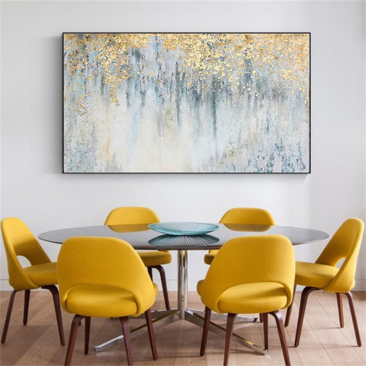 Room mockup. Gold-coloured textured foliage-like marks hang over fine dark vertical drips on a pale blue and white field.