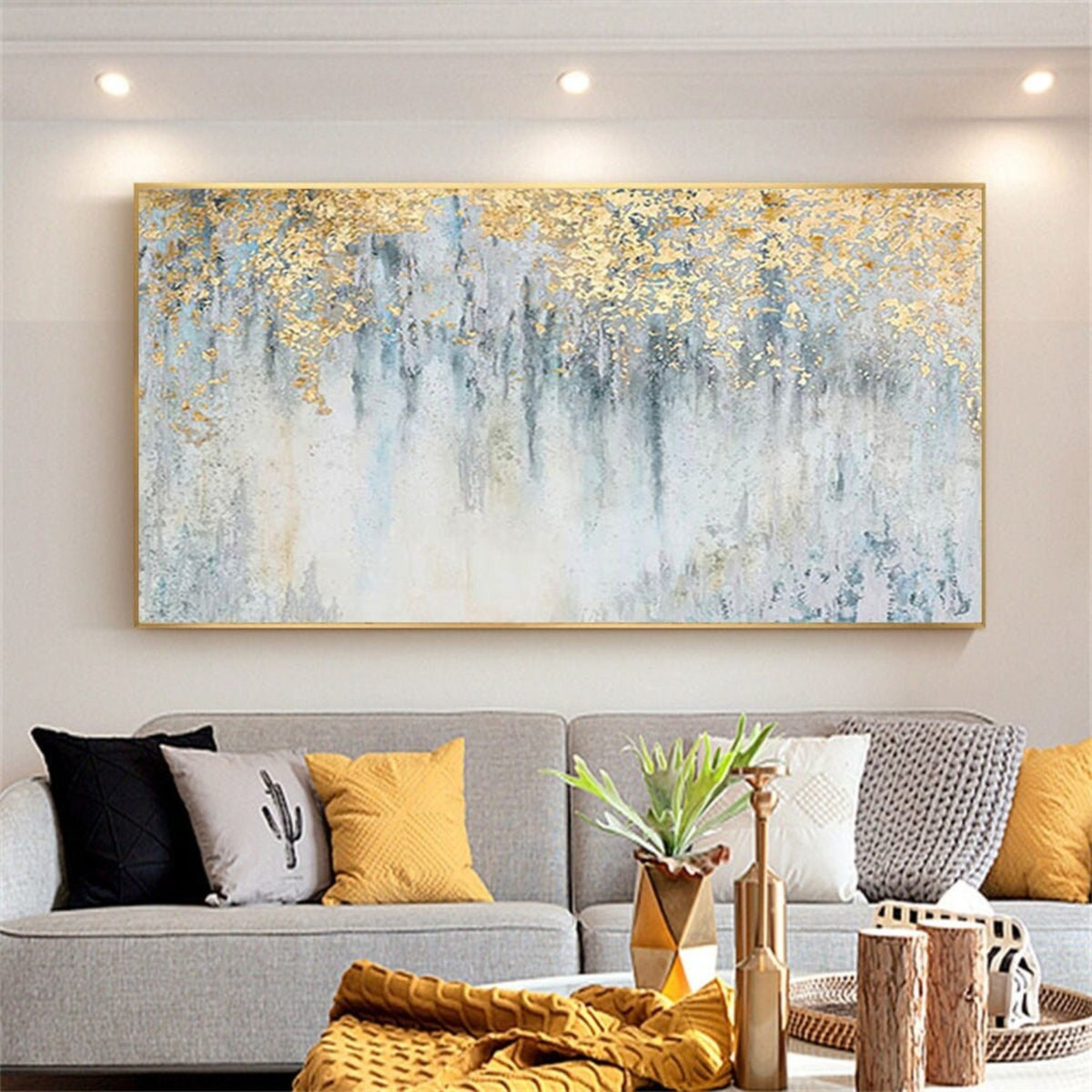 Room mockup. Gold-coloured textured foliage-like marks hang over fine dark vertical drips on a pale blue and white field.