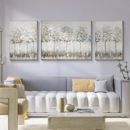 Room mockup. Three pale grey and cream tree panels with fine dark trunks, small light canopies and muted reflections below.