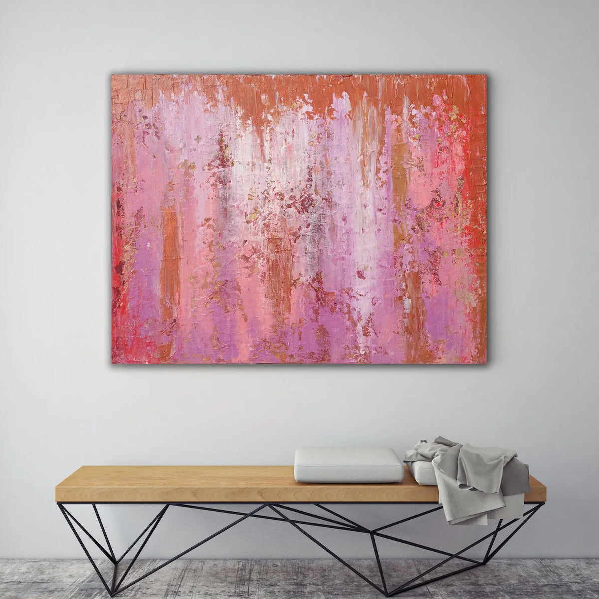 Room mockup showing pink and purple abstract painting with fine vertical drips, red accents and a narrow orange upper band.
