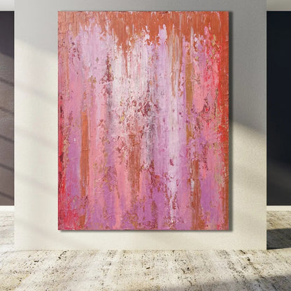 Room mockup showing pink and purple abstract painting with fine vertical drips, red accents and a narrow orange upper band.