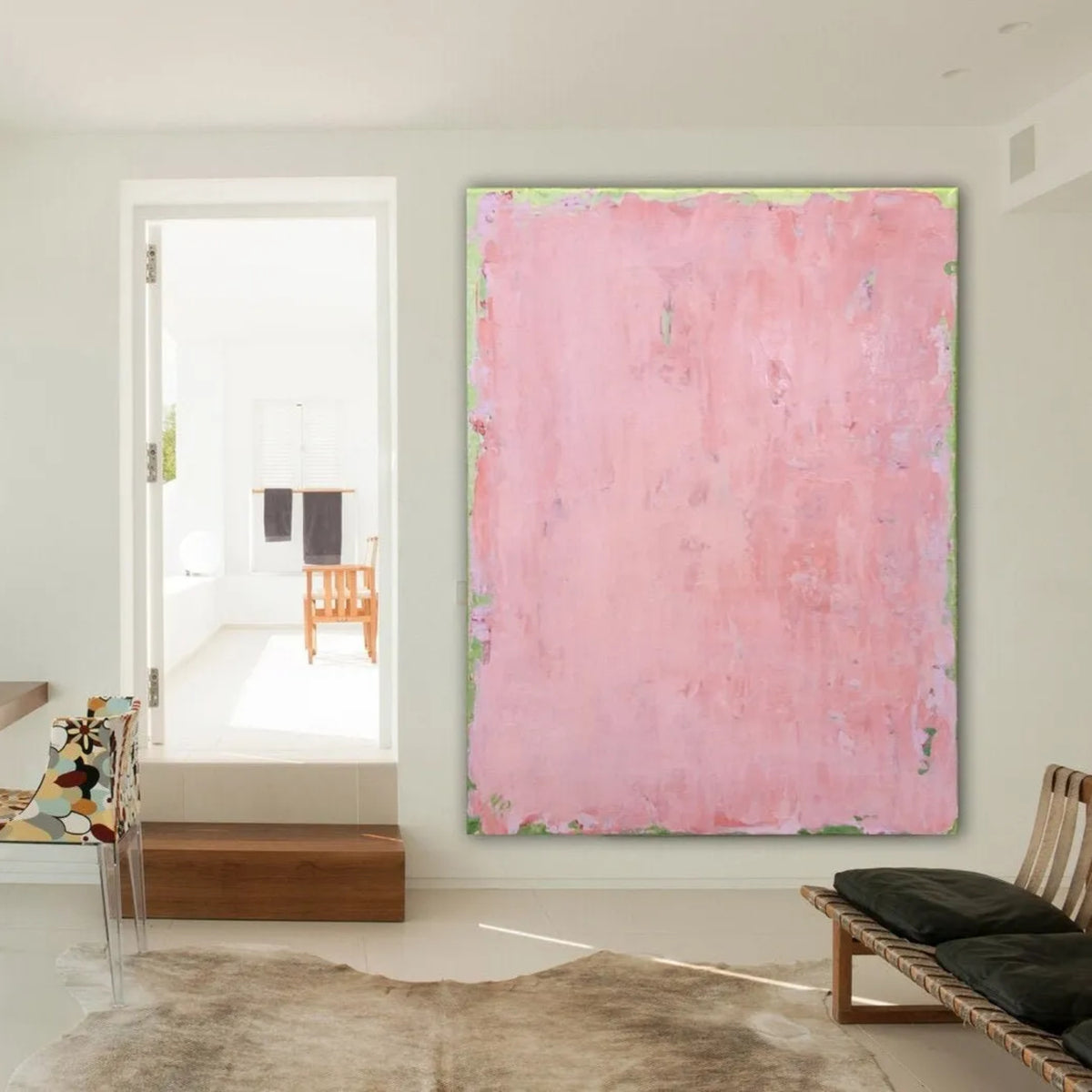Room mockup showing soft pink abstract painting with a mottled surface and thin pale green edging.