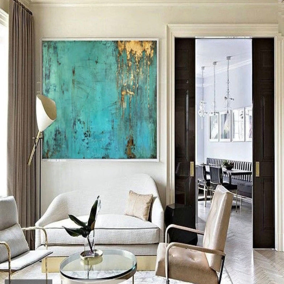 Room mockup. A turquoise textured field with fine dark scratched marks and gold-coloured patches dripping down from an upper edge.