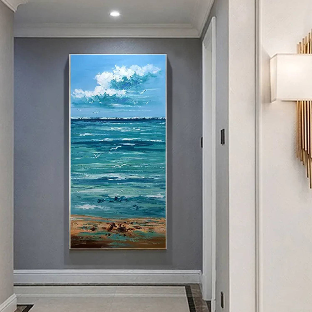 Room mockup. White cloud clusters above a turquoise sea with pale rippling waves, a sandy shore and small dark shorebirds.