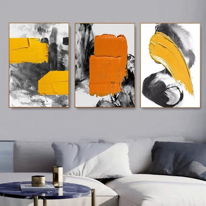 Room mockup. Three-panel abstract artwork with bold yellow and orange patches over gestural black, grey and white strokes.